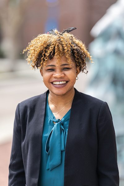 A portrait of Vida Opoku smiling outdoors on Loyola University Chicago's campus