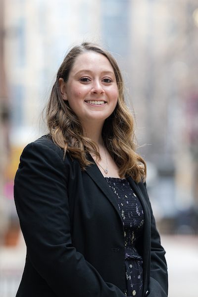 A portrait of Callie Kutasi smiling outdoors on Loyola University Chicago's campus