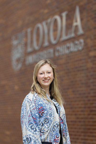 A portrait of Camille Morhun smiling outdoors on Loyola University Chicago's campus