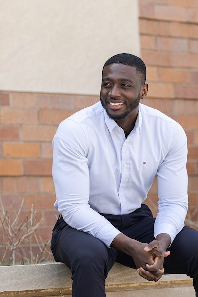A portrait of Nana Asante-Apeatu smiling outdoors on Loyola University Chicago's campus