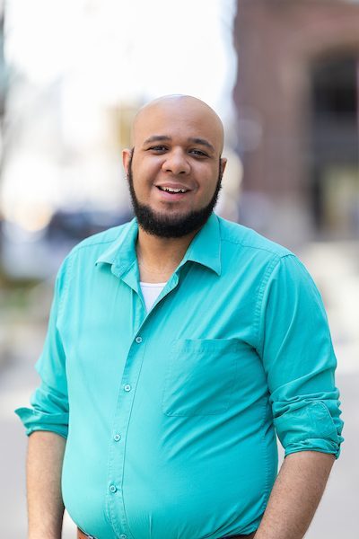 A portrait of Evan Nave smiling outdoors on Loyola University Chicago's campus