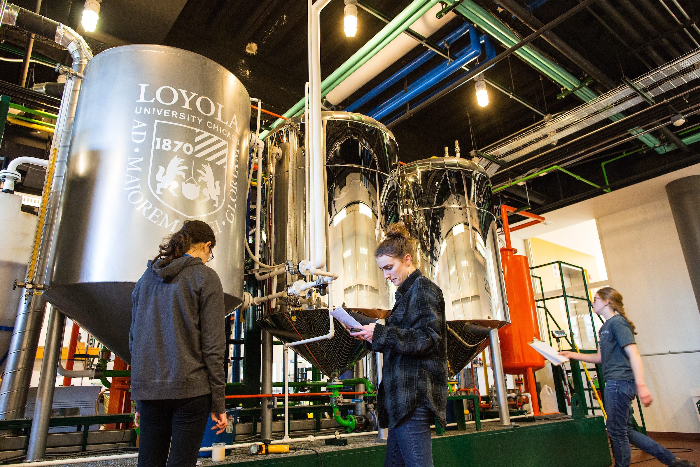 Loyola University Chicago sophomore Laura Orrico (left), senior Leena Swanson (middle) and junior Megan Tomerlin (right) work together in the Searle Biodiesel Lab on the Lake Shore Campus on Monday, February 26, 2018. (Photo: Lukas Keapproth)