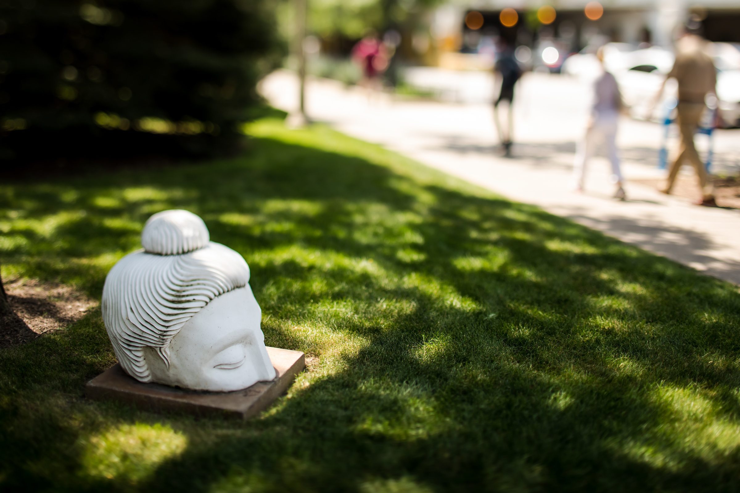 Buddha sculpture by Indira Freitas Johnson, a Chicago-area sculptor and nonviolence educator; installed November 2012. Rising from the grass at Sheridan Road and Loyola Avenue, this fiberglass sculpture is one of 100 identical Buddha heads that are part of Johnson’s Ten Thousand Ripples project. The project, which also includes cultural and community organizations from across Chicago, is meant to spark conversations and interactions about peace and nonviolence. (Photo: Lukas Keapproth)