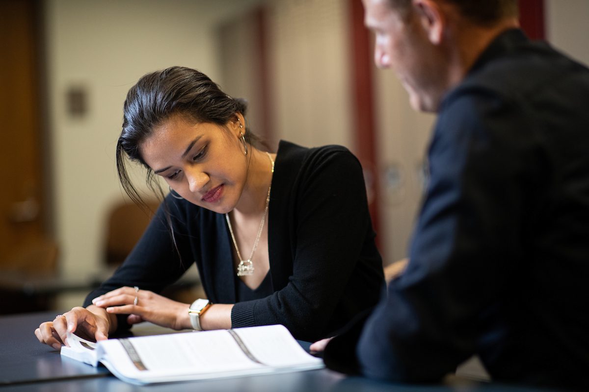 Arrupe College student Lady Carrillo studies with help from Arrupe faculty.