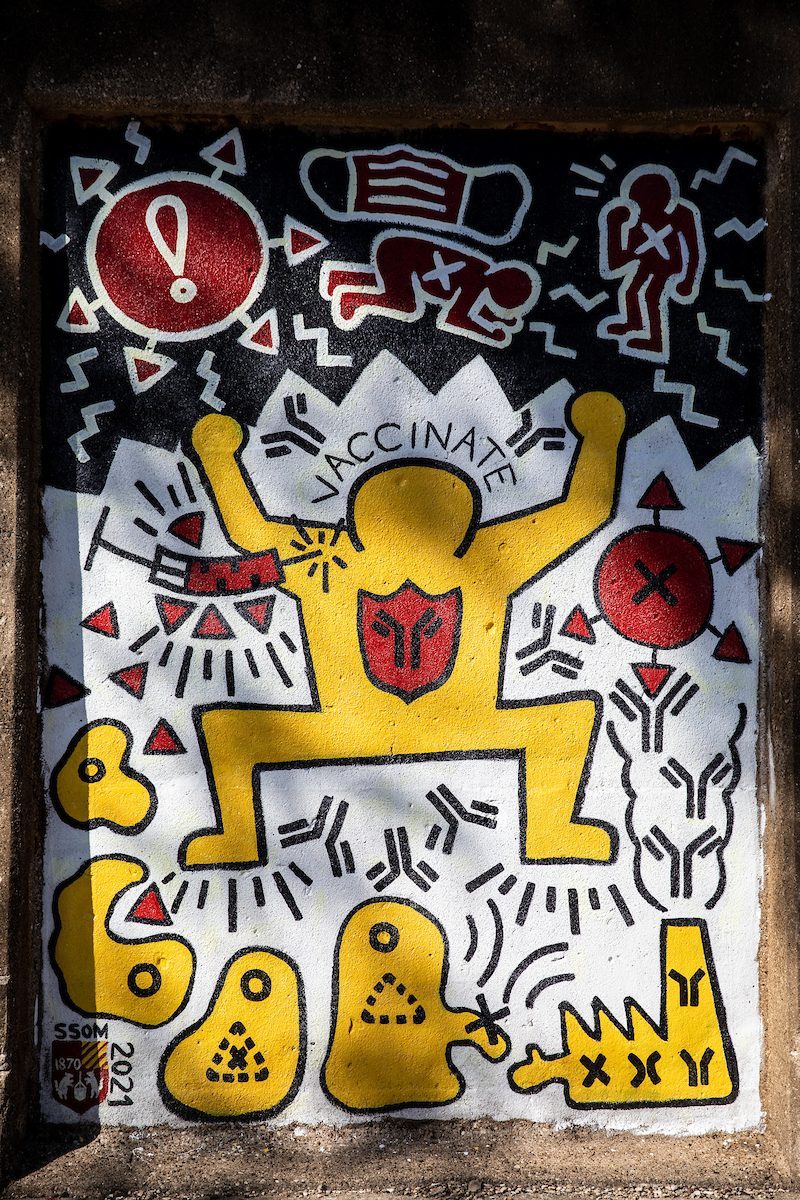 Stritch School of Medicine student Jamison Jones poses in front of his mural, 